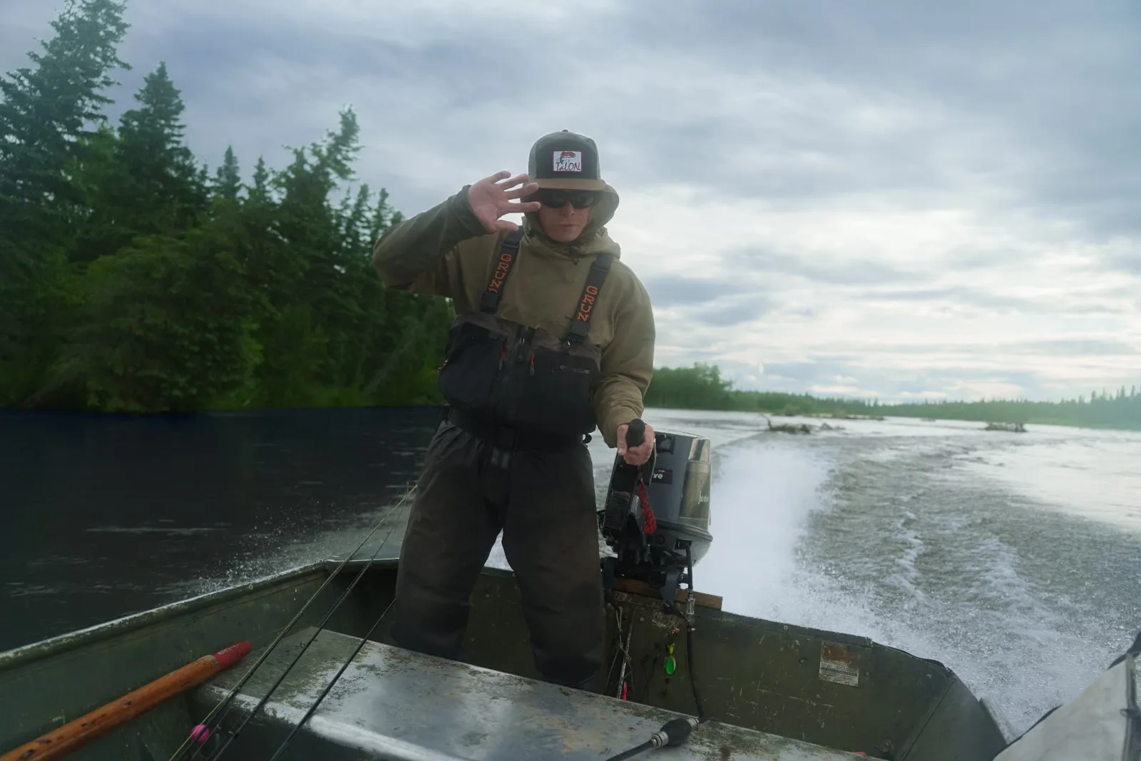 Guide driving the boat upriver on the Mulchatna
